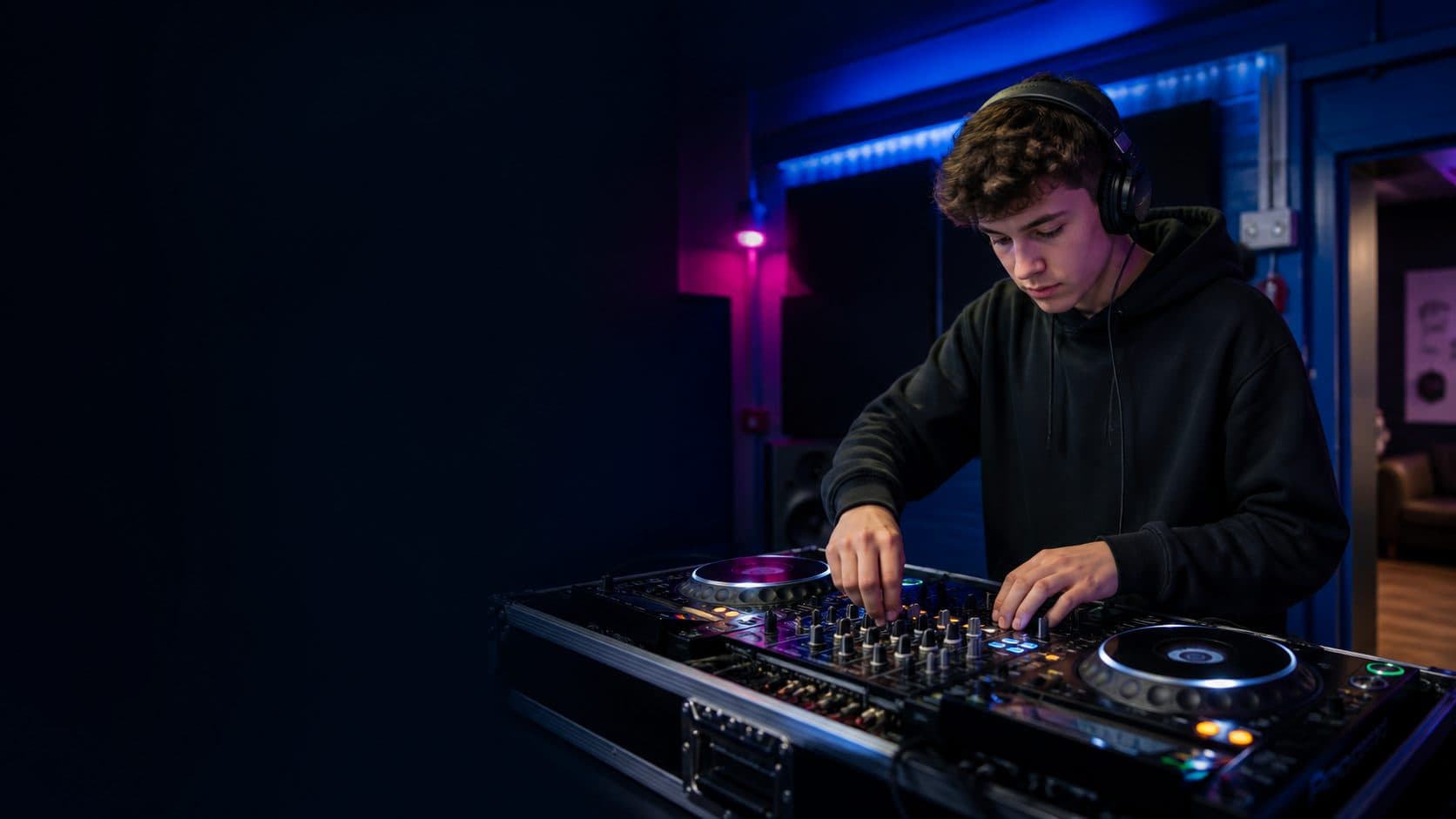 A young DJ learning to mix at NR1 Community