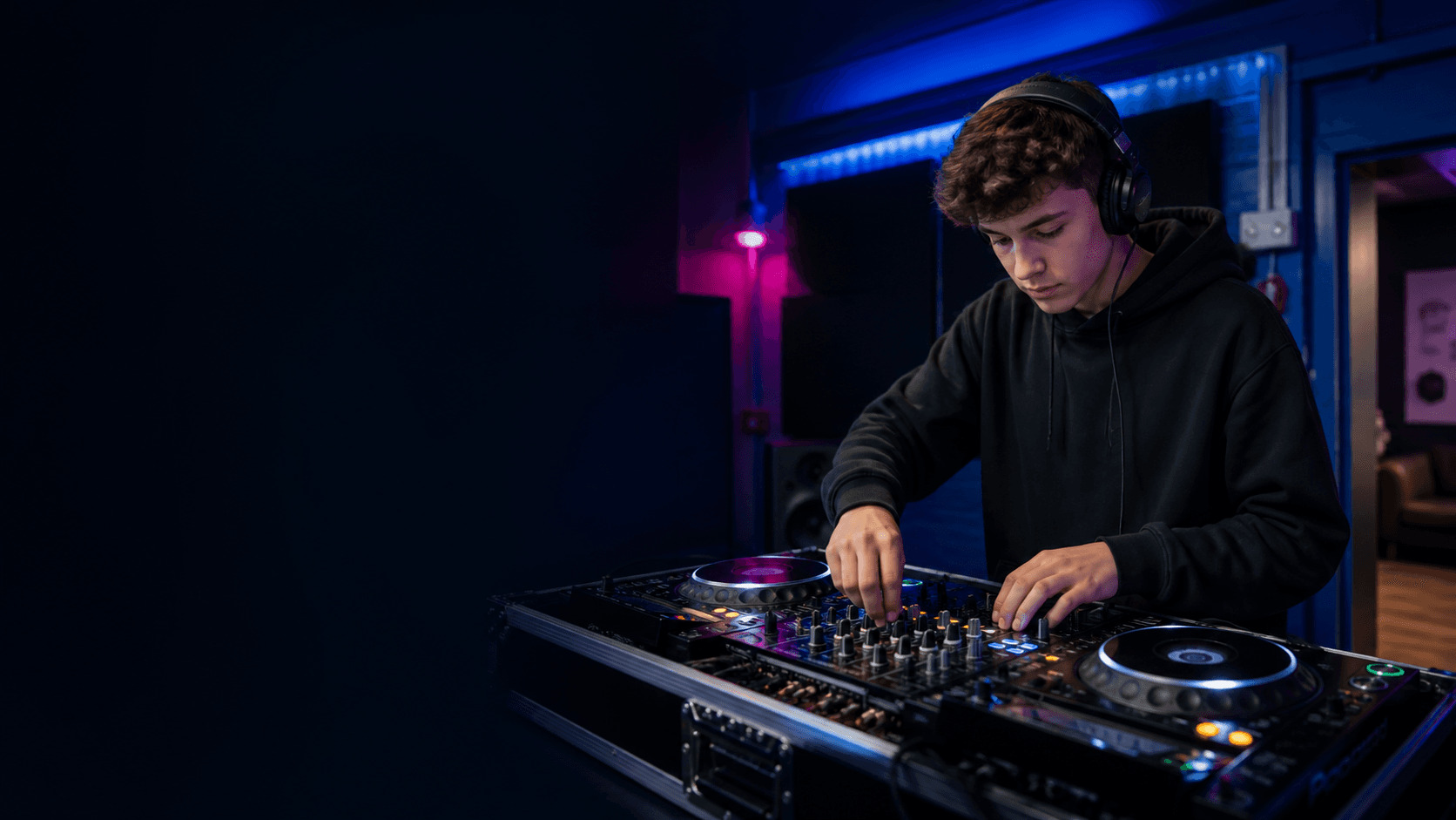 A young DJ learning to mix at NR1 Community